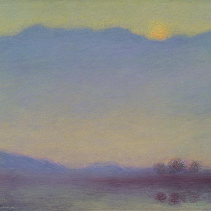 A serene landscape of a mountain range at sunrise